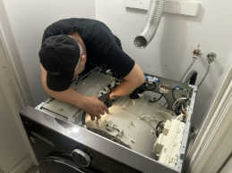 Technician repairing a washing machine in Davanagere