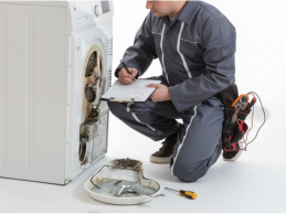 Technician repairing a top-load washing machine